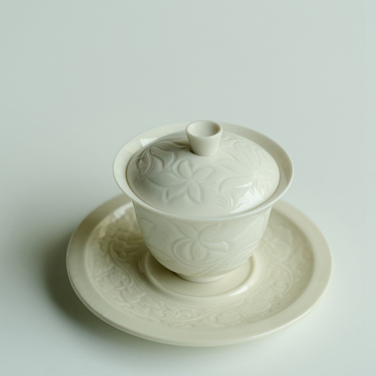 Ding Kiln Magnolia Pattern Ceramic Tea Cup with Saucer